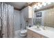 Bathroom with patterned wallpaper, shower and tub, and a sink with ample lighting at 5952 Brittania Blvd, Tavares, FL 32778