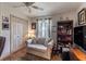 Cozy room featuring chair, dark bookshelf, window, and closet at 5952 Brittania Blvd, Tavares, FL 32778