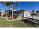 Charming single-story home with a two-car garage, screened porch, and nicely landscaped front yard at 5952 Brittania Blvd, Tavares, FL 32778