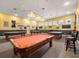 Game room featuring multiple pool tables, and bar seating, with bright lighting at 5952 Brittania Blvd, Tavares, FL 32778