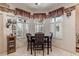 Bright breakfast nook with shuttered windows and a dark wood table sits adjacent to kitchen at 5952 Brittania Blvd, Tavares, FL 32778