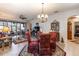 Formal living room features a ceiling fan, decorative chandelier, and sliding glass doors to the patio at 5952 Brittania Blvd, Tavares, FL 32778