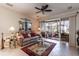 Comfortable living room with a ceiling fan, sliding glass doors leading to an outdoor seating area, and neutral-toned decor at 5952 Brittania Blvd, Tavares, FL 32778