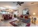 Cozy living room with a ceiling fan, sliding glass doors that lead to a screened patio, and comfortable furnishings at 5952 Brittania Blvd, Tavares, FL 32778