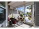 Relaxing screened porch with seating, offering a serene view of the beautifully landscaped front yard at 5952 Brittania Blvd, Tavares, FL 32778