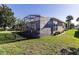 A view of the back of the home, showcasing the screened-in porch and well-maintained backyard at 5952 Brittania Blvd, Tavares, FL 32778