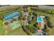 Enjoy community amenities including tennis, basketball, and a pool in this sunny aerial view at 6240 Tremayne Dr, Mount Dora, FL 32757