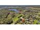 Aerial view of a residential community surrounded by lush green landscape and lakes at 6240 Tremayne Dr, Mount Dora, FL 32757