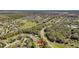 An aerial view showcases the property's location within a lush residential neighborhood and community amenities at 6240 Tremayne Dr, Mount Dora, FL 32757