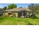 Exterior view of a home featuring a screened-in lanai and well-maintained backyard space at 6240 Tremayne Dr, Mount Dora, FL 32757