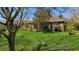 Lush green backyard featuring a spacious lawn and screened-in lanai, ideal for outdoor relaxation and activities at 6240 Tremayne Dr, Mount Dora, FL 32757