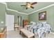 Green bedroom featuring chair rail, shutters, ceiling fan, and carpet flooring at 6240 Tremayne Dr, Mount Dora, FL 32757