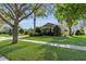 Well-manicured front lawn and landscaping enhancing the curb appeal of this charming single-Gathering home at 6240 Tremayne Dr, Mount Dora, FL 32757