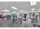 Well-equipped fitness center with cardio machines, weights, and ample natural light at 6240 Tremayne Dr, Mount Dora, FL 32757