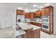 Modern kitchen with stainless steel appliances, a breakfast bar, and white marble countertops at 6240 Tremayne Dr, Mount Dora, FL 32757