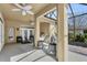 Enclosed patio with ceiling fans and outdoor furniture, creating a relaxing space at 6240 Tremayne Dr, Mount Dora, FL 32757