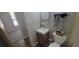 Comfortable bathroom featuring a white sink and toilet, alongside charming decorative touches at 6720 Se 107Th St, Belleview, FL 34420