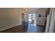 Dining room with hardwood floors, neutral colors, and sliding glass doors to the backyard at 6720 Se 107Th St, Belleview, FL 34420