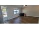 Well-lit room with hardwood floors, a window, and neutral color palette at 6720 Se 107Th St, Belleview, FL 34420