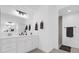 Bright bathroom showcasing dual sink vanity with a large mirror and modern lighting at 674 Waterman Way, The Villages, FL 32163