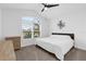 Cozy bedroom featuring a ceiling fan, natural light, and minimalist decor at 674 Waterman Way, The Villages, FL 32163