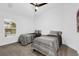 Bright bedroom featuring ceiling fan and a large window at 674 Waterman Way, The Villages, FL 32163