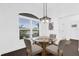 Charming breakfast nook featuring dark wood floors, a glass table, and a bright window view at 674 Waterman Way, The Villages, FL 32163