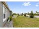 A well-manicured front yard with landscaped greenery and decorative elements at 674 Waterman Way, The Villages, FL 32163