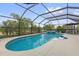 A beautiful screened pool with a spa surrounded by tropical plants, perfect for relaxation at 674 Waterman Way, The Villages, FL 32163