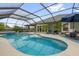 Enclosed pool area with a jacuzzi, outdoor seating, lounge chairs, and well-maintained landscaping at 674 Waterman Way, The Villages, FL 32163