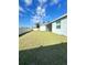 A fenced backyard featuring green lawn and partial home view with blue skies overhead at 6853 Se 3Rd Loop, Ocala, FL 34472