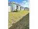 Spacious fenced yard featuring green grass and house exterior at 6853 Se 3Rd Loop, Ocala, FL 34472