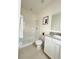 Bathroom with tiled shower, white vanity and granite countertop at 6853 Se 3Rd Loop, Ocala, FL 34472