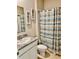 Bathroom with granite countertops, framed mirrors, and a shower with striped curtain at 6853 Se 3Rd Loop, Ocala, FL 34472