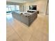 Open living room featuring tiled flooring and ample natural light from sliding glass door at 6853 Se 3Rd Loop, Ocala, FL 34472