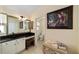 A bathroom features a sink with white cabinets, a makeup counter, and access to the toilet at 686 Aberdeen Run, The Villages, FL 32162