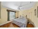 Bedroom with hardwood floors, ceiling fan, and natural light from window at 686 Aberdeen Run, The Villages, FL 32162