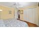 Bedroom featuring hardwood floors, white closets, and a ceiling fan at 686 Aberdeen Run, The Villages, FL 32162