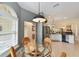 Bright dining area with a glass table, seating for four, seamlessly connecting to the modern kitchen with ample countertop space at 686 Aberdeen Run, The Villages, FL 32162