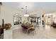 Elegant dining room featuring a round table, decorative mirror, and stylish chandelier at 686 Aberdeen Run, The Villages, FL 32162