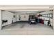 Open garage view showcasing ample space, golf cart, and organizational features at 686 Aberdeen Run, The Villages, FL 32162