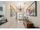 Hallway features tile flooring, decorative art, and chandelier lighting fixture at 686 Aberdeen Run, The Villages, FL 32162