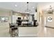 Stylish kitchen boasts black countertops, white cabinetry and modern hanging light fixture at 686 Aberdeen Run, The Villages, FL 32162