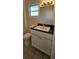 Bathroom offers a granite countertop, a modern sink fixture, and a decorative mirror at 709 S Highland St, Mount Dora, FL 32757