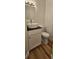 Modern half-bathroom with a vessel sink, a black countertop and tile floors at 709 S Highland St, Mount Dora, FL 32757