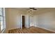 Bright bedroom featuring hardwood floors, a ceiling fan, and natural light at 709 S Highland St, Mount Dora, FL 32757