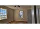Bright bedroom with wood-look flooring, large windows, and a ceiling fan, capturing natural light at 709 S Highland St, Mount Dora, FL 32757