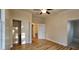 The bedroom has a ceiling fan, wood-look flooring, a closet, and access to the ensuite bath at 709 S Highland St, Mount Dora, FL 32757