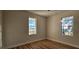 Bedroom featuring hardwood floors, ceiling fan, and window views at 709 S Highland St, Mount Dora, FL 32757