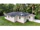 Rear exterior of home showcasing lush backyard and architectural details at 709 S Highland St, Mount Dora, FL 32757